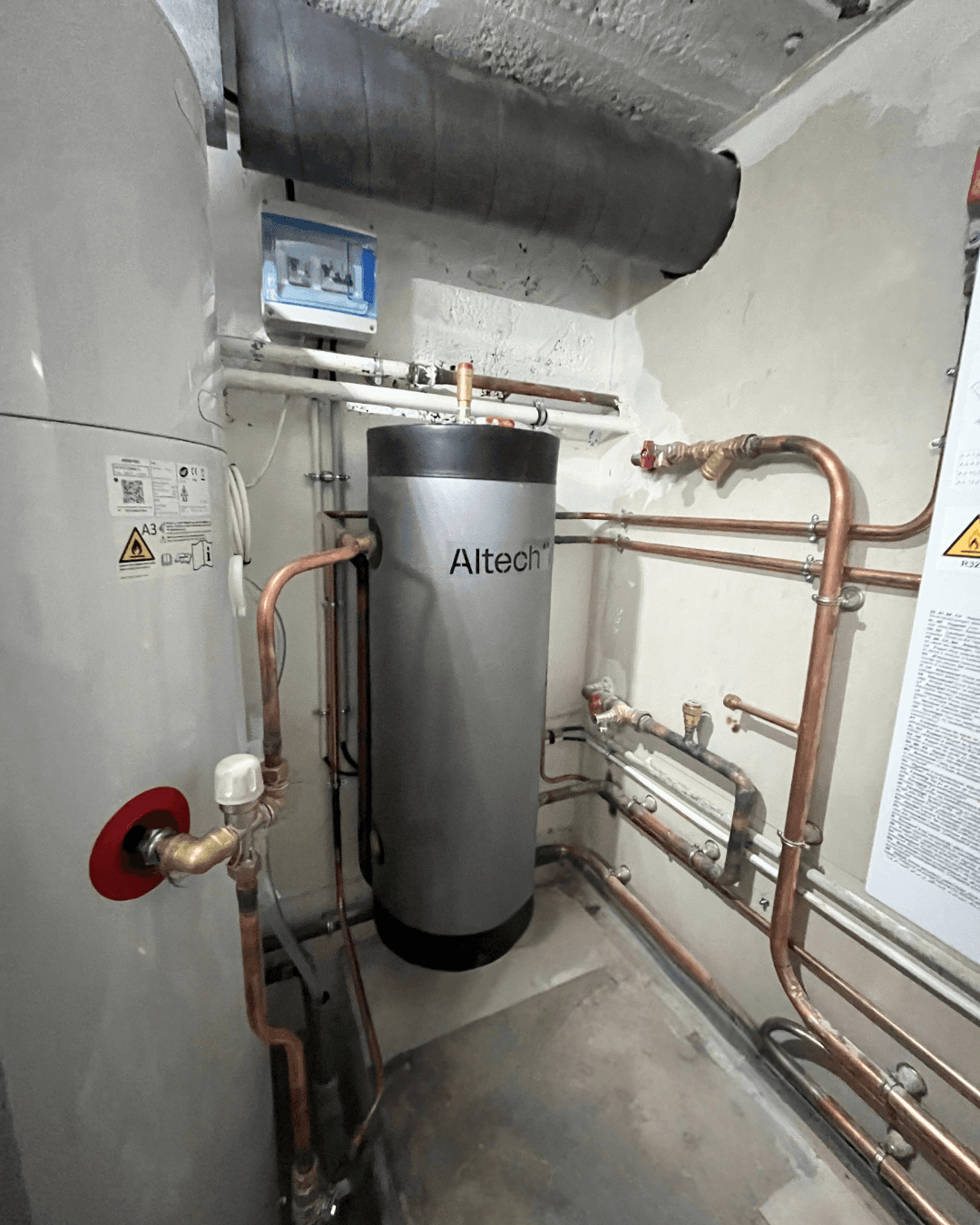 Installation finalisée d'un ballon tampon Altech et de ses réseaux de distribution en cuivre pour l'optimisation du système de chauffage.